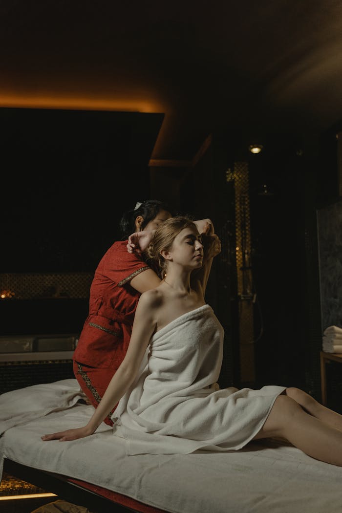 A tranquil spa massage experience with a woman receiving professional therapy in a calming environment.